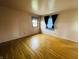 A spacious bedroom with hardwood floors and ample natural light from a window with blue shades at 1387 W Furry Rd, Fountaintown, IN 46130