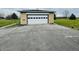 Detached garage with a white door, offering secure parking and additional storage space at 1387 W Furry Rd, Fountaintown, IN 46130