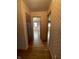 A hallway that features hardwood floors and decorative wallpaper, connecting various rooms within the home at 1387 W Furry Rd, Fountaintown, IN 46130
