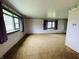 Living room featuring a large bay window, vintage wallpaper, and brown carpeted floors at 1387 W Furry Rd, Fountaintown, IN 46130