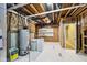 Unfinished basement area with exposed pipes, a water heater, shelving, and concrete flooring at 14814 Edgebrook Dr, Fishers, IN 46040