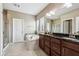Bathroom featuring double sinks, dark wood cabinets, and a separate tub and shower at 14814 Edgebrook Dr, Fishers, IN 46040