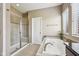 Bright bathroom with a glass shower, a soaking tub, and modern fixtures at 14814 Edgebrook Dr, Fishers, IN 46040