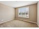 Well-lit bedroom features neutral walls, carpet flooring, and a window to the exterior at 14814 Edgebrook Dr, Fishers, IN 46040