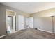 A spacious carpeted bedroom featuring neutral color walls and multiple doors at 14814 Edgebrook Dr, Fishers, IN 46040
