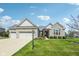 Charming single-story home with stone facade, three-car garage, and well-manicured front lawn at 14814 Edgebrook Dr, Fishers, IN 46040