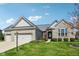 Charming single-story home with stone facade, three-car garage, and well-manicured front lawn at 14814 Edgebrook Dr, Fishers, IN 46040