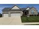 Charming single-story home with stone facade, three-car garage, and well-manicured front lawn at 14814 Edgebrook Dr, Fishers, IN 46040