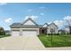Charming single-story home with stone facade, three-car garage, and well-manicured front lawn at 14814 Edgebrook Dr, Fishers, IN 46040
