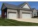 Two-car garage with ample parking space and stone exterior at 14814 Edgebrook Dr, Fishers, IN 46040