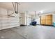 Spacious three car garage with epoxy flooring, overhead lighting, and ample storage space at 14814 Edgebrook Dr, Fishers, IN 46040