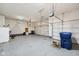 Clean three car garage featuring epoxy flooring, multiple doors, and access to storage at 14814 Edgebrook Dr, Fishers, IN 46040