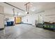 Well-lit three car garage featuring epoxy flooring, storage cabinets, and access to the house at 14814 Edgebrook Dr, Fishers, IN 46040