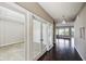 Hallway featuring a chandelier and view of an office through glass paneled French doors at 14814 Edgebrook Dr, Fishers, IN 46040
