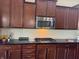 Kitchen featuring dark wood cabinets, stainless steel appliances, and a white subway tile backsplash at 14814 Edgebrook Dr, Fishers, IN 46040
