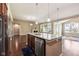 Gourmet kitchen with stainless steel appliances, granite island, and a view into the adjacent living area at 14814 Edgebrook Dr, Fishers, IN 46040