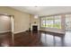 Spacious living room featuring hardwood floors, fireplace, and large windows at 14814 Edgebrook Dr, Fishers, IN 46040