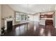 Spacious living room featuring hardwood floors, fireplace, and seamless flow into the kitchen at 14814 Edgebrook Dr, Fishers, IN 46040