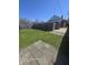 Lush backyard with a well-maintained lawn, a fenced border, and a stone patio at 1640 Lawton Ave, Columbus, IN 47201