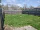 A grassy backyard with a wooden fence at 1640 Lawton Ave, Columbus, IN 47201