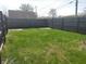 Large, grassy backyard enclosed by a wooden fence, perfect for outdoor activities and privacy at 1640 Lawton Ave, Columbus, IN 47201