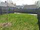 A grassy backyard with a wooden fence and a small tree at 1640 Lawton Ave, Columbus, IN 47201