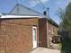 The home's exterior shows a brick wall and white door at 1640 Lawton Ave, Columbus, IN 47201