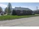 Classic brick home with well maintained lawn and a covered front porch with white railings at 1640 Lawton Ave, Columbus, IN 47201