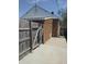 Home's exterior featuring a brick wall, a wooden fence and a concrete walkway at 1640 Lawton Ave, Columbus, IN 47201