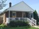 Lovely brick home showcasing a covered front porch, perfect for relaxing and enjoying the outdoors at 1640 Lawton Ave, Columbus, IN 47201