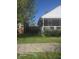 Quaint front yard with a charming porch, manicured shrubs, and a brick facade at 1640 Lawton Ave, Columbus, IN 47201