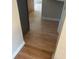 Hallway featuring wood laminate flooring, connecting different rooms and spaces in the house at 1640 Lawton Ave, Columbus, IN 47201