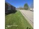Well-kept yard featuring green grass extending along the side of the property and street at 1640 Lawton Ave, Columbus, IN 47201