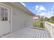 Back porch with white painted wood planks, white railing, and a white door at 1739 N Alton Ave, Indianapolis, IN 46222