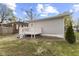 View of the backyard showing a wooden deck with steps leading to the grass yard at 1739 N Alton Ave, Indianapolis, IN 46222