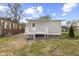 View of the backyard showing a wooden deck with steps leading to the grass yard at 1739 N Alton Ave, Indianapolis, IN 46222