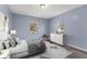 Bright bedroom with a plush bed, white dresser, chair, and serene decor at 1739 N Alton Ave, Indianapolis, IN 46222