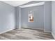 Clean bedroom with gray vinyl flooring, fresh paint, and bright window at 1739 N Alton Ave, Indianapolis, IN 46222