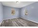 Bright bedroom with two windows, gray vinyl floors and fresh paint at 1739 N Alton Ave, Indianapolis, IN 46222