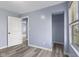 Well-lit bedroom with new gray vinyl floors, fresh paint, and ample closet space at 1739 N Alton Ave, Indianapolis, IN 46222