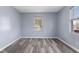 Sunlit bedroom with modern gray vinyl floors and neutral, fresh paint at 1739 N Alton Ave, Indianapolis, IN 46222