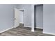 Bedroom featuring gray vinyl flooring, fresh paint, doorway and spacious closet at 1739 N Alton Ave, Indianapolis, IN 46222