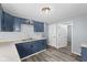 Kitchen featuring blue cabinets and wood-look flooring at 1739 N Alton Ave, Indianapolis, IN 46222