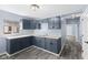 Kitchen with blue cabinetry, white countertops and stainless steel hardware at 1739 N Alton Ave, Indianapolis, IN 46222