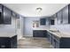 Bright kitchen with blue cabinets, white countertops, and wood-look floors at 1739 N Alton Ave, Indianapolis, IN 46222