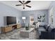 Cozy living room featuring hardwood floors, a modern sofa, and a stylish entertainment center at 1739 N Alton Ave, Indianapolis, IN 46222