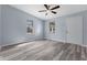 Open-concept living room featuring modern gray vinyl floors and a contemporary ceiling fan at 1739 N Alton Ave, Indianapolis, IN 46222
