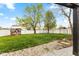 Large backyard with a playhouse, white fence, and plenty of green space for recreation at 1792 Salina Dr, Avon, IN 46123