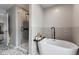 Bathroom with a freestanding tub, glass shower, and elegant tile work at 1792 Salina Dr, Avon, IN 46123