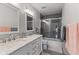 Bathroom featuring dual sinks, decorative tile floor, and tiled shower with glass doors at 1792 Salina Dr, Avon, IN 46123